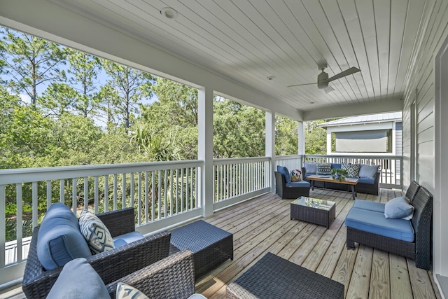 wooden terrace featuring outdoor lounge area and a ceiling fan