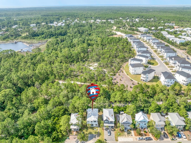 bird's eye view featuring a water view, a residential view, and a wooded view