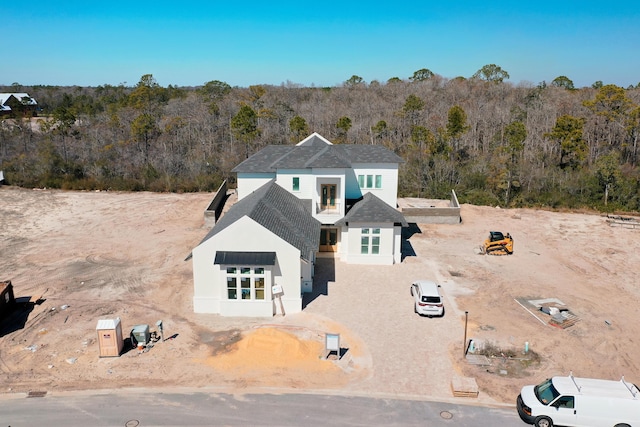 view of front of property featuring a forest view