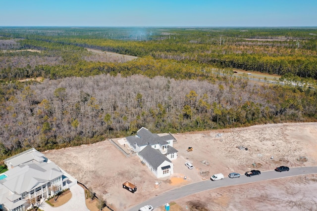 drone / aerial view with a wooded view