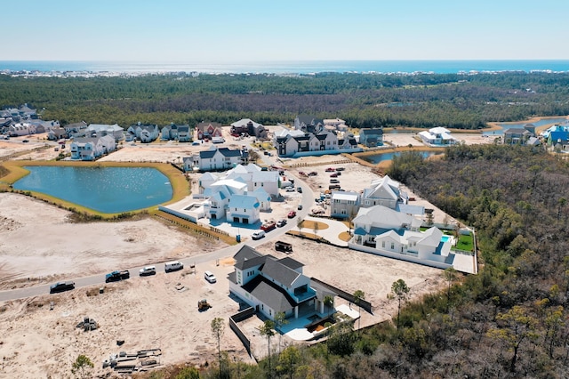 aerial view featuring a water view, a residential view, and a view of trees