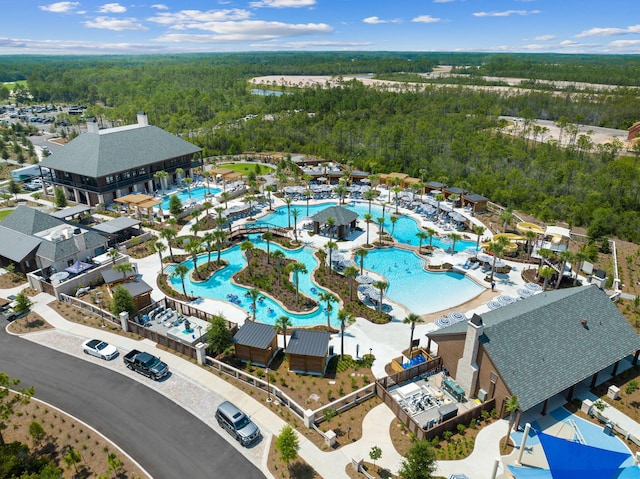 birds eye view of property featuring a view of trees