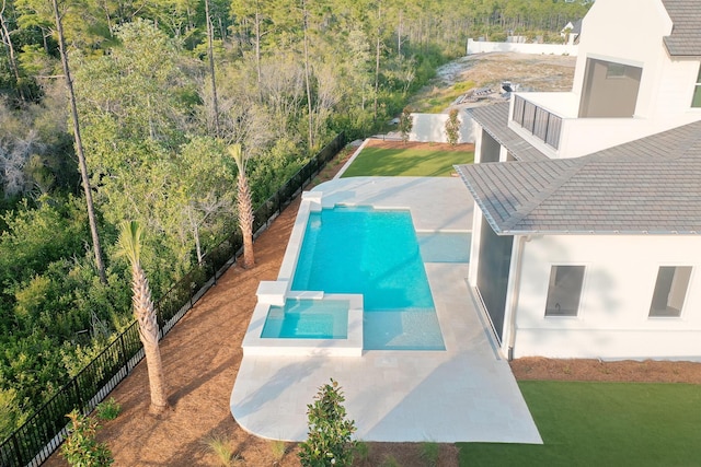 147 Quail Hollow Ct, Watersound, FL 32461 - view of swimming pool with a wooded view, a pool with connected hot tub, a patio area, and fence