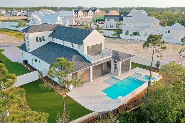 147 Quail Hollow Ct, Watersound, FL 32461 - rear view of house with a balcony, a residential view, a patio area, and a pool with connected hot tub