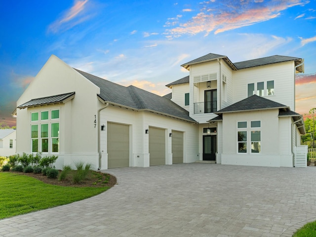 147 Quail Hollow Ct, Watersound, FL 32461 - view of front facade featuring a balcony, an attached garage, decorative driveway, and a yard