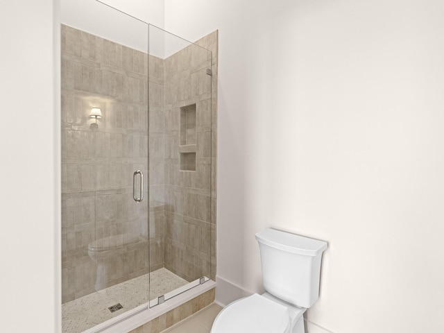 147 Quail Hollow Ct, Watersound, FL 32461 - bathroom featuring toilet, a stall shower, tile patterned floors, and baseboards