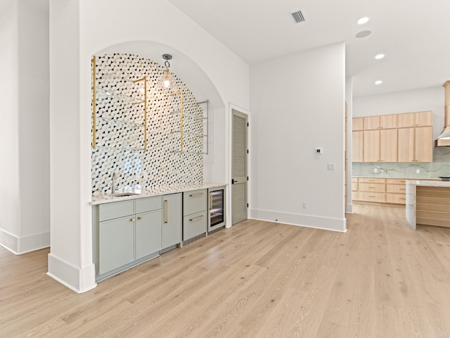 147 Quail Hollow Ct, Watersound, FL 32461 - bar featuring wine cooler, a sink, light wood-type flooring, tasteful backsplash, and recessed lighting
