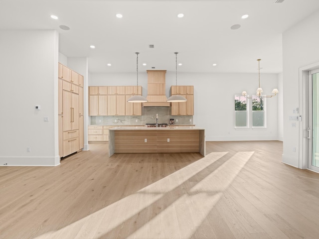 147 Quail Hollow Ct, Watersound, FL 32461 - kitchen featuring light brown cabinetry, a sink, modern cabinets, light countertops, and light wood finished floors