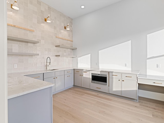 147 Quail Hollow Ct, Watersound, FL 32461 - kitchen with open shelves, a sink, gray cabinetry, light wood-type flooring, and recessed lighting