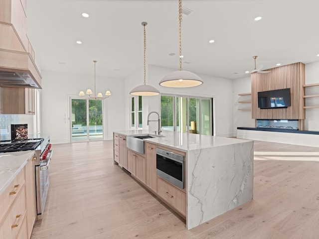 147 Quail Hollow Ct, Watersound, FL 32461 - kitchen featuring a sink, stainless steel stove, light brown cabinetry, a fireplace, and custom range hood