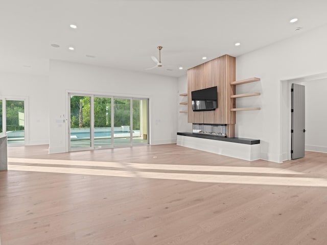 147 Quail Hollow Ct, Watersound, FL 32461 - unfurnished living room featuring a fireplace, recessed lighting, light wood-style floors, baseboards, and ceiling fan