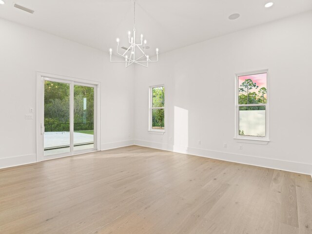 147 Quail Hollow Ct, Watersound, FL 32461 - unfurnished room featuring a chandelier, light wood-type flooring, and baseboards
