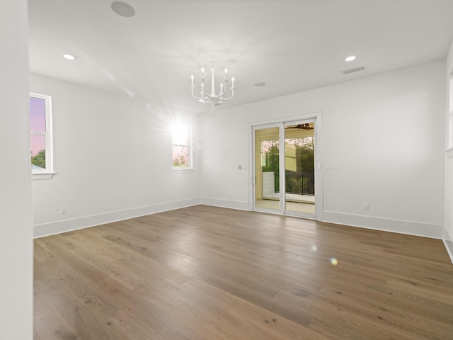 147 Quail Hollow Ct, Watersound, FL 32461 - spare room with a chandelier, wood finished floors, baseboards, and recessed lighting