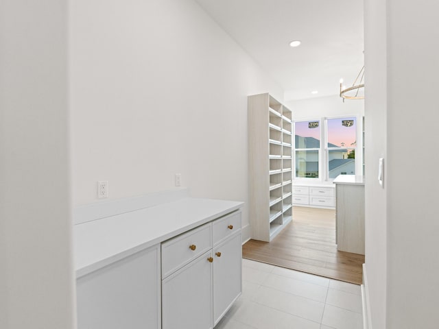 147 Quail Hollow Ct, Watersound, FL 32461 - hall featuring light tile patterned floors, a chandelier, and recessed lighting
