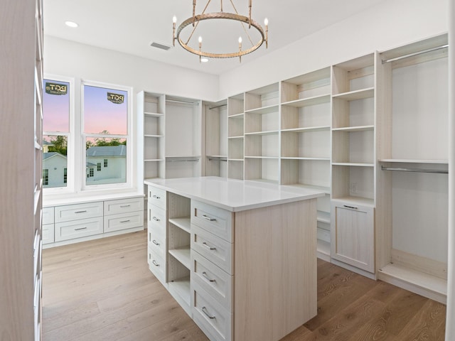 147 Quail Hollow Ct, Watersound, FL 32461 - spacious closet featuring a chandelier and light wood-type flooring