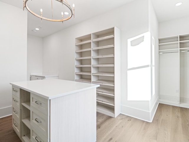 147 Quail Hollow Ct, Watersound, FL 32461 - spacious closet with light wood-style floors and a chandelier