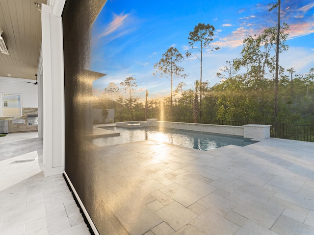 147 Quail Hollow Ct, Watersound, FL 32461 - pool at dusk with exterior kitchen and a patio area