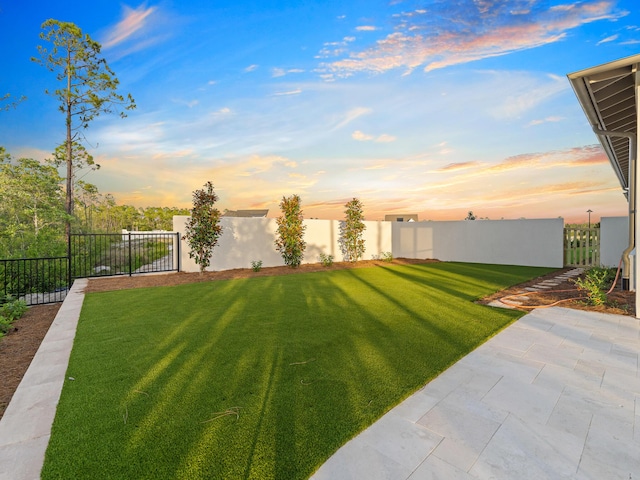 147 Quail Hollow Ct, Watersound, FL 32461 - yard at dusk featuring a patio area