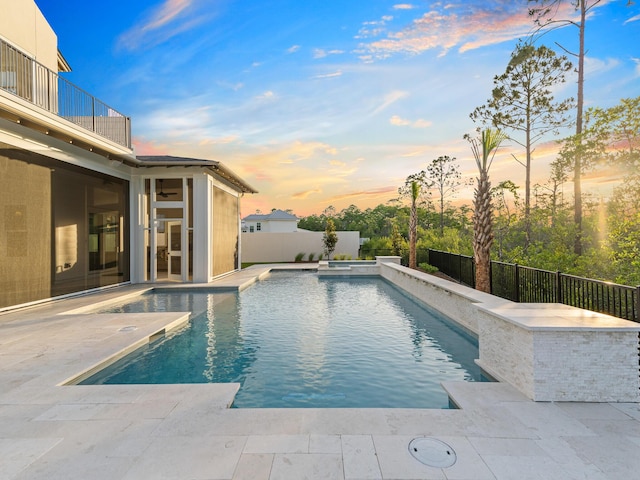 147 Quail Hollow Ct, Watersound, FL 32461 - pool at dusk featuring a fenced backyard and a patio area