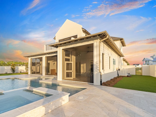 147 Quail Hollow Ct, Watersound, FL 32461 - rear view of house featuring a patio area, a sunroom, a fenced backyard, and a pool with connected hot tub