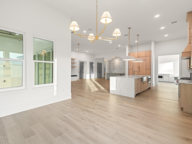 147 Quail Hollow Ct, Watersound, FL 32461 - kitchen with a chandelier, recessed lighting, light wood-type flooring, pendant lighting, and a center island with sink