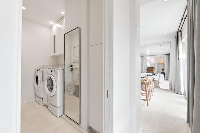 laundry room featuring recessed lighting, cabinet space, and washer and dryer