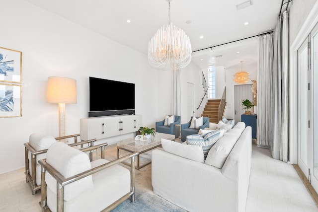 living room featuring stairway, visible vents, a notable chandelier, and recessed lighting