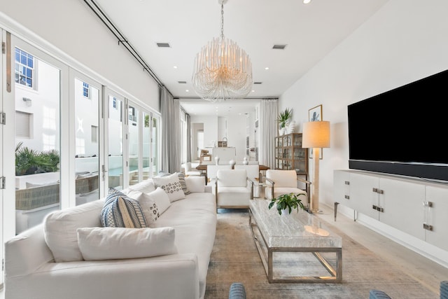 living area with visible vents, a chandelier, and recessed lighting