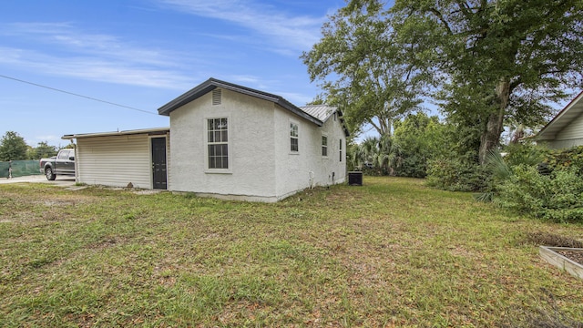 view of side of property with a yard