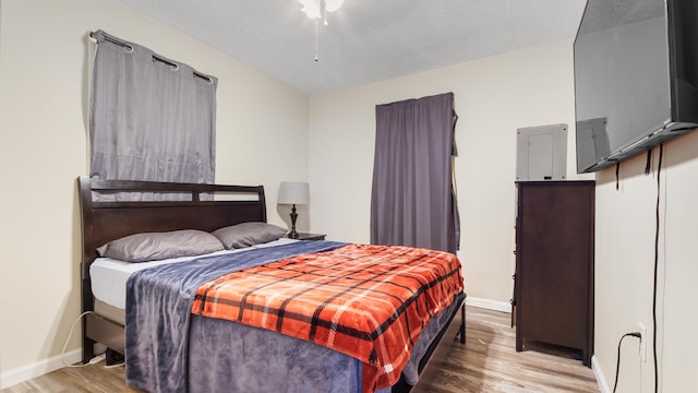 bedroom with hardwood / wood-style flooring and a textured ceiling