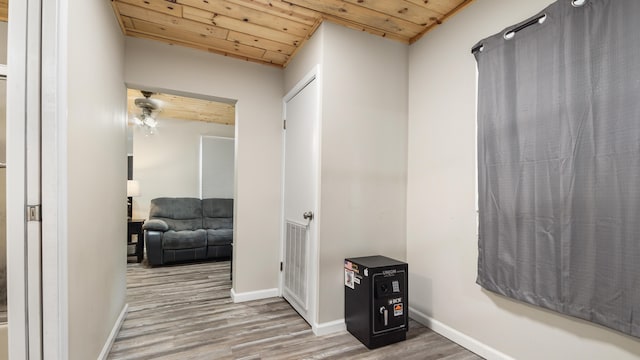 corridor with wood ceiling and hardwood / wood-style flooring