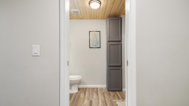 bathroom with toilet, hardwood / wood-style floors, and wooden ceiling