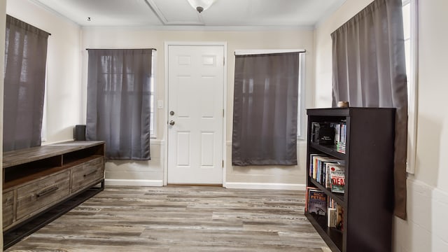 entryway featuring hardwood / wood-style flooring and crown molding