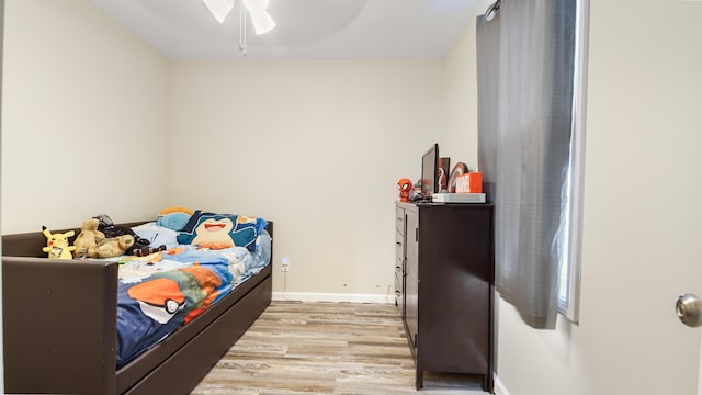 bedroom with ceiling fan and light hardwood / wood-style floors