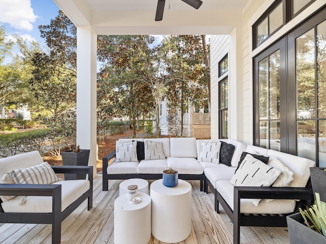 wooden terrace featuring an outdoor hangout area and ceiling fan