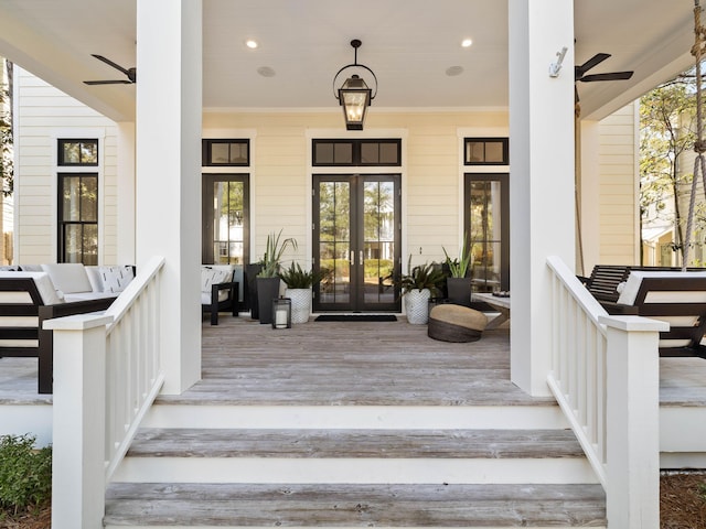 entrance to property with ceiling fan, a porch, and french doors