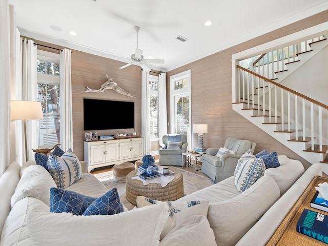 living area featuring stairs, ornamental molding, a wealth of natural light, and recessed lighting