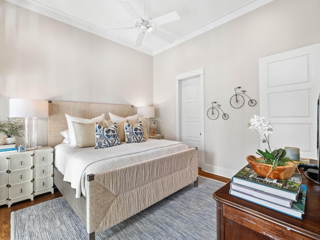 bedroom with crown molding, dark wood finished floors, baseboards, and a ceiling fan