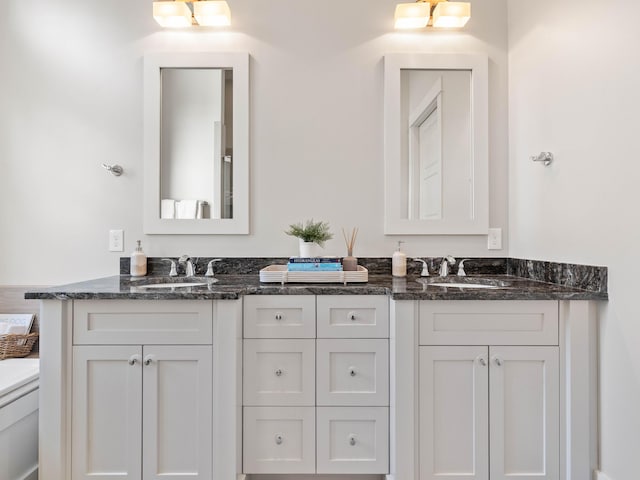 full bath with double vanity and a sink