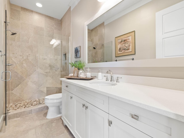 bathroom featuring toilet, a shower stall, vanity, and recessed lighting