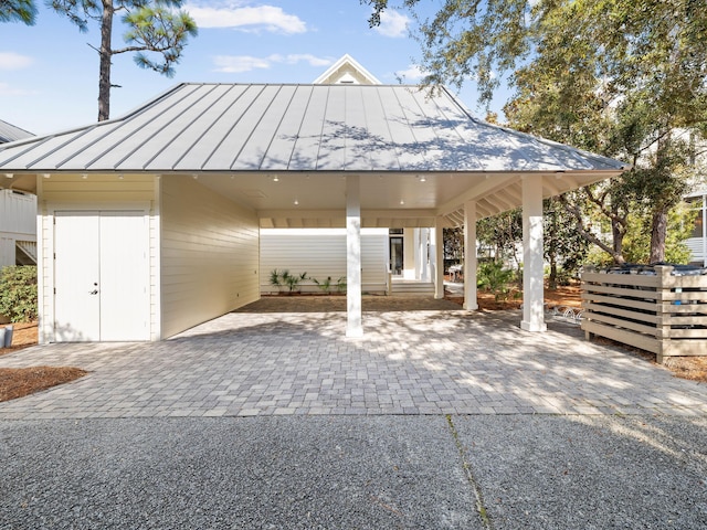 view of car parking with driveway and an attached carport