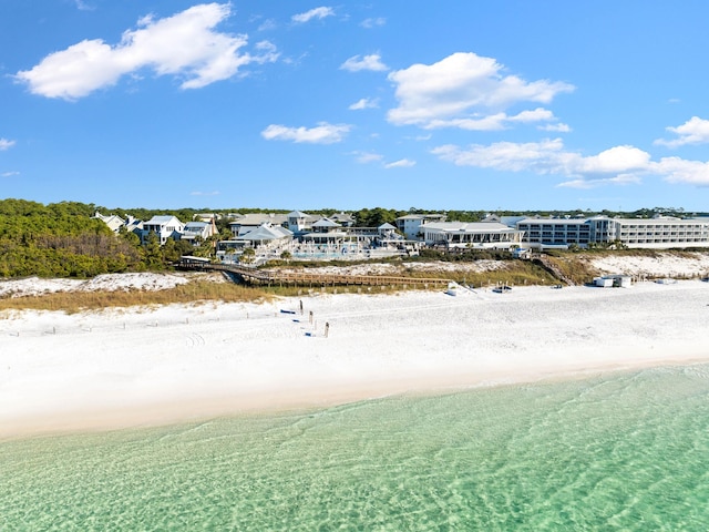 birds eye view of property with a view of the beach and a water view