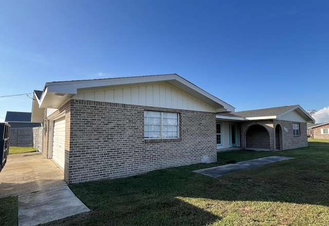 view of property exterior with a yard and a garage