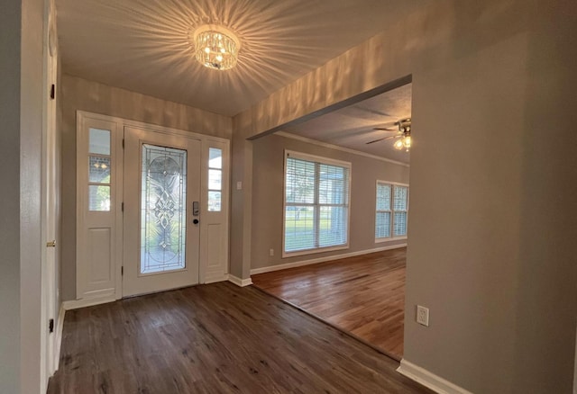 entrance foyer with dark wood-type flooring and ornamental molding