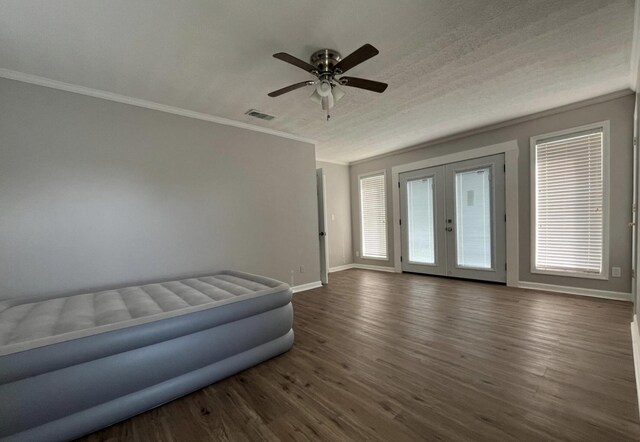 interior space featuring ornamental molding, dark hardwood / wood-style floors, ceiling fan, and french doors