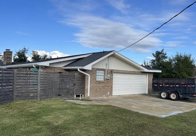 view of home's exterior with a yard and a garage