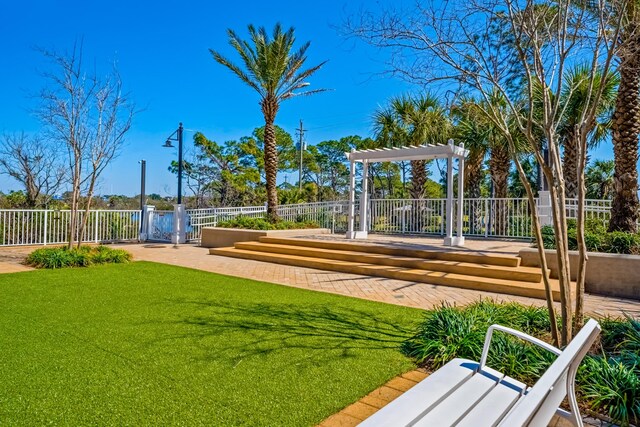 9860 S Thomas Dr Unit 921, Panama City Beach, FL 32408 - surrounding community featuring a yard, fence, a gate, and a pergola