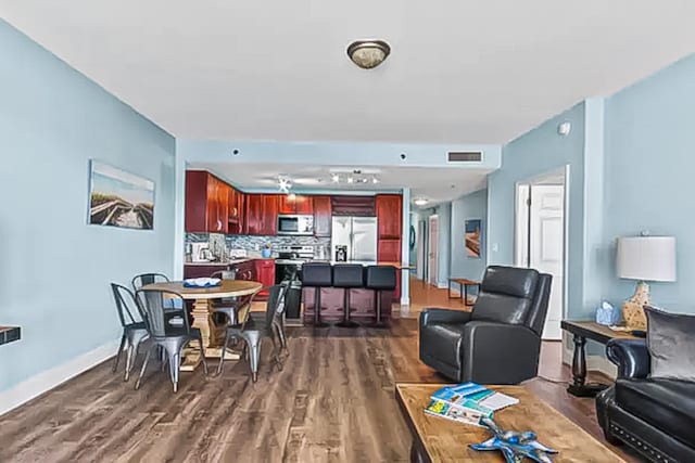 9860 S Thomas Dr Unit 921, Panama City Beach, FL 32408 - dining area with baseboards, visible vents, and dark wood-type flooring