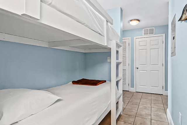 9860 S Thomas Dr Unit 921, Panama City Beach, FL 32408 - bedroom with visible vents, baseboards, and light tile patterned flooring
