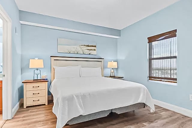 9860 S Thomas Dr Unit 921, Panama City Beach, FL 32408 - bedroom featuring light wood-style flooring and baseboards